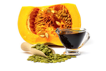 Pumpkin seed and pumpkin seed oil on background of raw pumpkin isolated on white background.