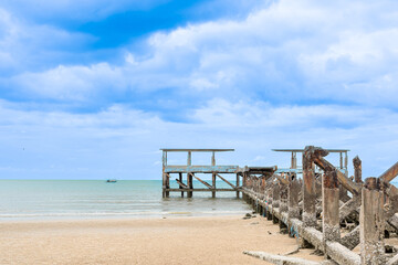 Close up Old port for fishing boats, old cement structure broken on the beach and sea rain cloud sky in background,Landmark  Pranburi,Prachuap Khiri Khan Thailand