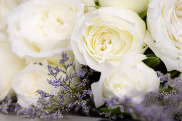 Beautiful big and a luxury bouquet of white roses arranged in a bunch. Close up shot with details