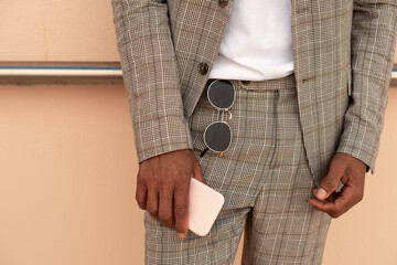 Close-up of African American man holding phone. Male hand holding modern device. Technology concept