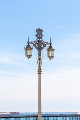 Fototapeta na wymiar Brigthon light post with pier in the backgrounf