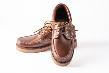 Pair of brown leather moccasin shoes isolated on white background