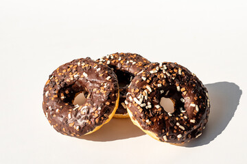 Chocolate donuts. Donuts with colorful sprinkles isolated on white background. 