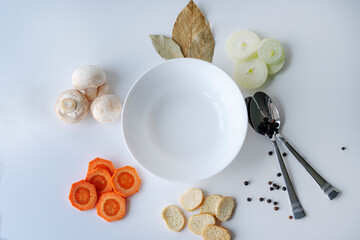 Ingredients for making mushroom soup. Various ingredients for cooking vegetable soup on a white background. Vegan food.
