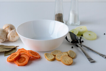 Ingredients for making mushroom soup. Various ingredients for cooking vegetable soup on a white background. Vegan food.