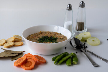 Vegetable soup. Ingredients for making mushroom soup. Various ingredients for cooking vegetable soup on a white background. Vegan food.