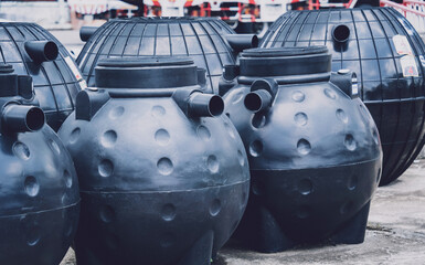 black plastic water storage tanks at the manufacturer factory depot