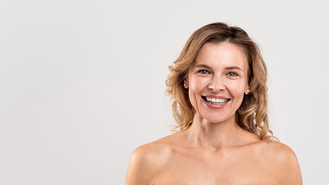 Natural Beauty. Portrait Of Attractive Smiling Middle Aged Woman With Naked Shoulders