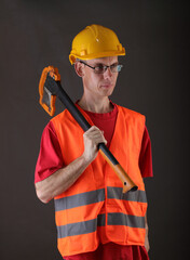 worker in a helmet holding an ax