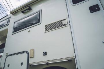 Travel camp trailer car with on the ground with grass