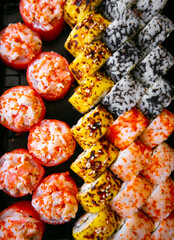 Sushi Set nigiri and sushi rolls on black stone plate board top view