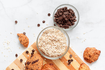 Top view of homemade oat cookies with chocolate. Healthy breakfast served on wood board. Rustic snack for a healthy lifestyle.