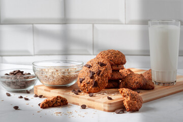 Close up of homemade oat cookies with chocolate. Healthy breakfast served on wood board. Rustic snack for a healthy lifestyle.