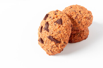 Oat cookies with chocolate on white background for cutting out. Rustic snack for a healthy lifestyle.