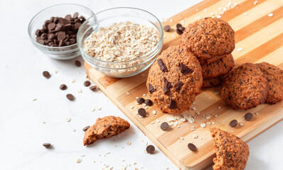 Close up of homemade oat cookies with chocolate. Healthy breakfast served on wood board. Rustic snack for a healthy lifestyle.