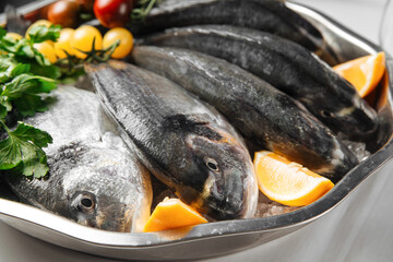 Closeup on fresh raw fish for cooking in a metal bowl