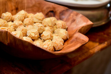 hazelnut candies on wooden tray, condensed milk candy balls, condensed milk candy balls, candy balls