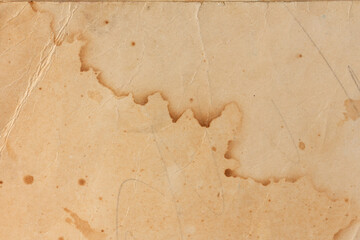 Old yellowed paper with stains from water