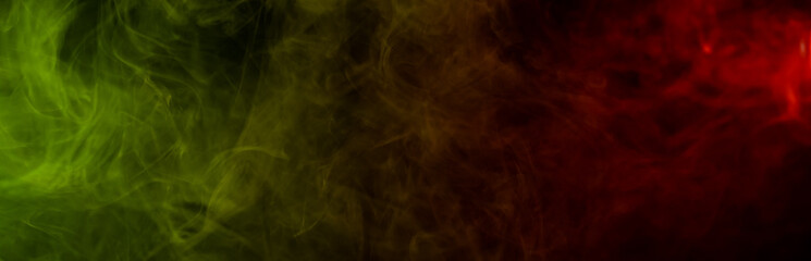 Red yellow green smoke on a black background.