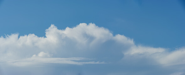 Cumulus and stratus clouds against the blue sky.
