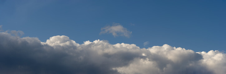 Cumulus clouds against the blue sky.