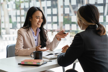 Asian business young people having business meeting discussing business ideas together colleagues brainstorm negotiate at briefing in boardroom, business meeting ideas and brainstorming