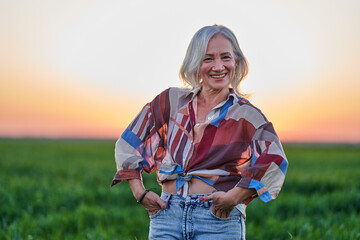 Senior farmer with white hair in a wheat field