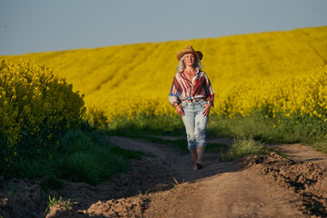 Senior woman in a canola field