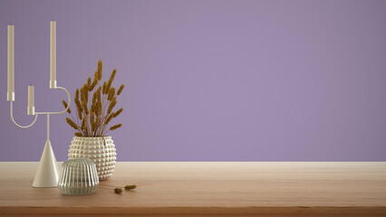 Empty interior design concept, wooden table, desk or shelf close up. Ceramic and glass vases with dry plants, straws. Purple background with copy space, template mock up idea