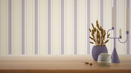 Empty interior design concept, wooden table, desk or shelf close up in purple tones. Ceramic and glass vases with dry plants, straws. Striped wallpaper with copy space, template
