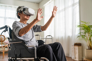 lonely ole male Disabled Senior Man in a Wheelchair Gesturing and concentrate While Wearing the Virtual Reality Goggles at Home in the Livingroom,Shot of a senior man in a wheelchair wear vr headset