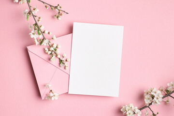 Blank greeting card mockup with envelope and white flowers © nikavera