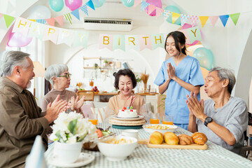 birthday party at senior daycare,group of asian female elder male female laugh smile positive...