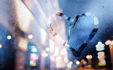 love heart draw on rain sweaty glass over defocused shopping mall light bokeh background