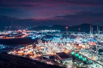 Aerial view of factory zone Oil and gas industry - refinery stores tank and Petrochemical plant on island at twilight over lighting