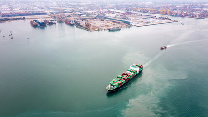 container ship sailing to transport goods in containers for import export internationally and worldwide, business services transportation by container ship open sea, aerial view photograph from drone,