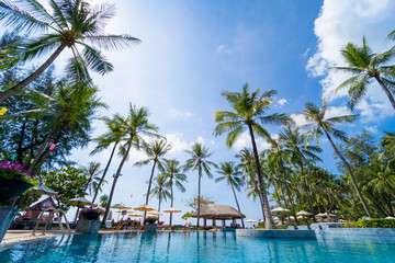 Amazing tropical paradise beach with swimming pools and coconut palms