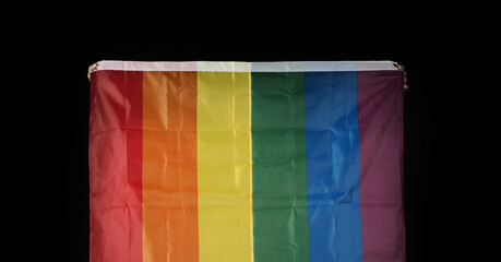 Fototapeta na wymiar LGBTQ pride flag on black background. Lgbt rainbow flag in gay hand. Represent symbol of freedom peace equality and love and respect diversity of sexuality. Lesbian Gay Bi sexsual Transgender Queer.