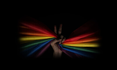LGBTQ pride flag on black background. Lgbt rainbow flag in gay hand. Represent symbol of freedom peace equality and love and respect  diversity of sexuality. Lesbian Gay Bi sexsual Transgender Queer. - obrazy, fototapety, plakaty