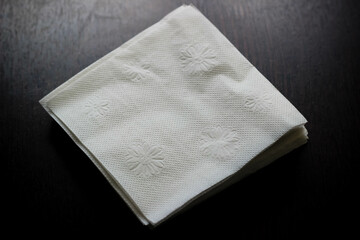 white paper napkins on a wooden table