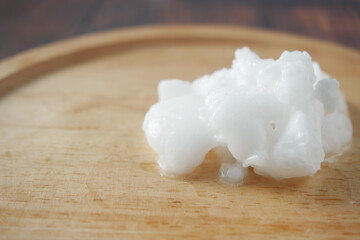 cold coconut oil on wooden board ,