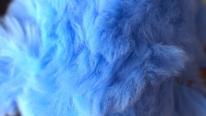 Blue faux fur. long pile. Children's toy. Piece of clothing. animal protection. Substitute for natural fur. fabric production. close-up.