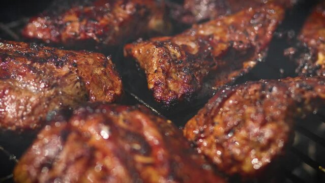 Tasty ribs cooking on barbecue grill for summer outdoor party