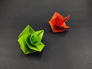 Two colored origami rose petals isolated on black background, Not Focus