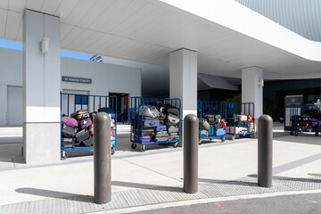 
Miami, FL, USA - January 2, 2022: Luggage trolleys with baggage at the baggage drop-off area in a cruise terminal, Miami, FL, USA.   
