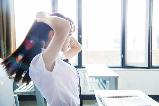 A girl in a JK uniform inside