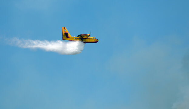 Athens, Greece, June 4, 2022: A firefighting Canadair CL-215 aircraft operates in Hymettus mount wildfire near Glyfada suburb of Athens.