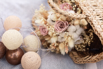 Dried bridal bouquet with decor on a plaid.