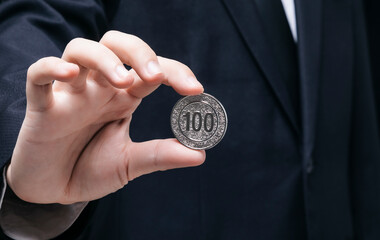 professional man holding a coin