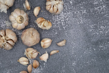 Fresh raw garlic on dark background for cooking concept set up